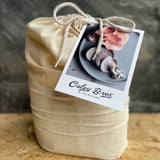 Gift bag and postcard with mushrooms on it, on a wooden board