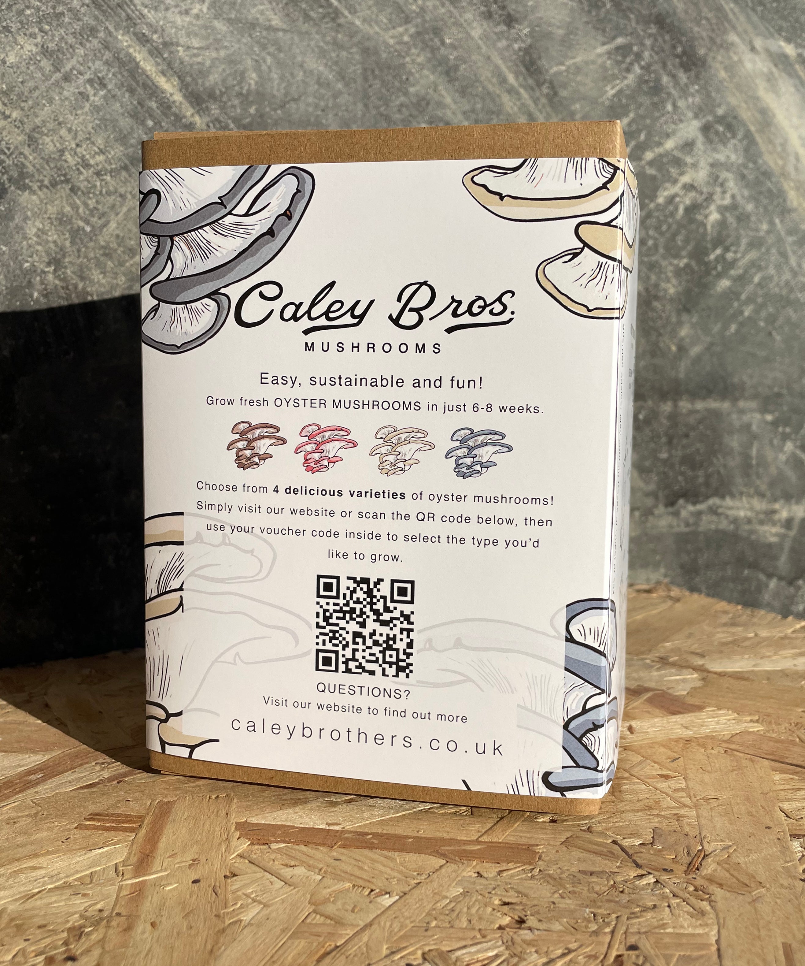 Caley Bros mushroom kit packaging with QR code on a wooden surface