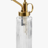 Clear glass bottle with gold metal nozzle on a white background