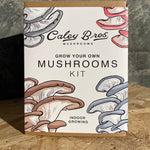 Caley Bros mushroom growing kit packaging with illustrations of mushrooms on a wooden surface.