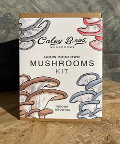Caley Bros mushroom growing kit packaging with illustrations of mushrooms on a wooden surface.